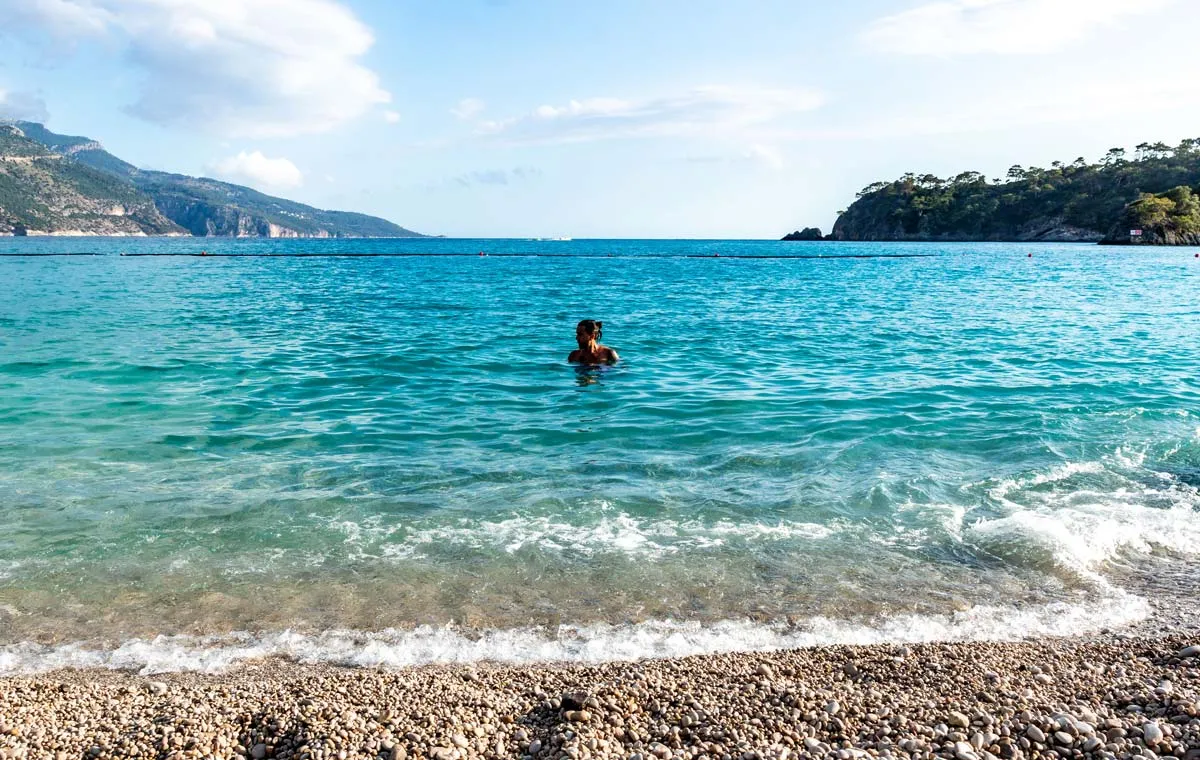 Homem dentro do mar na praia de Oludeniz na Turquia