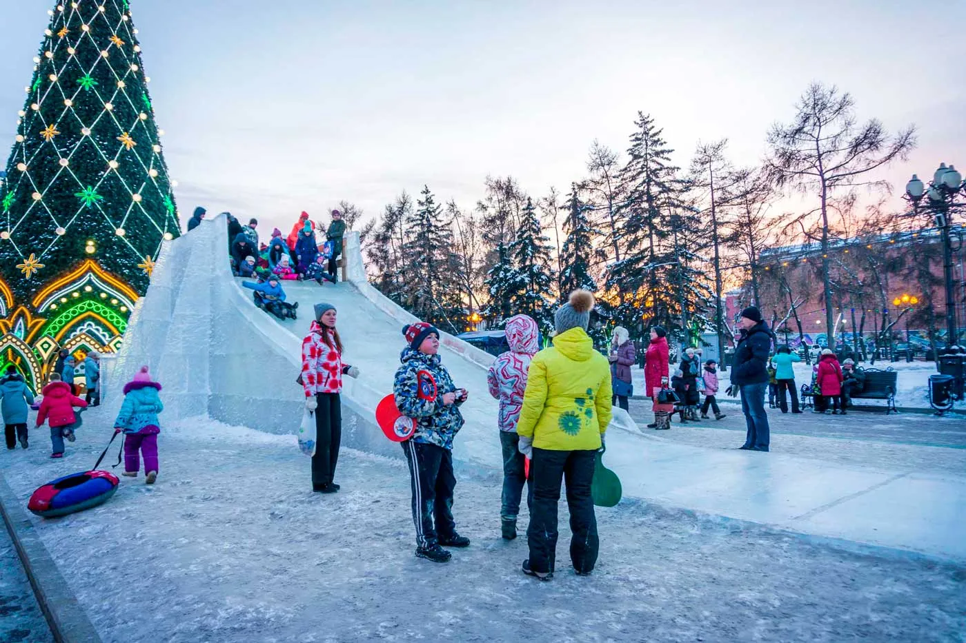 Crianças brincando nas esculturas de gelo da Praça Kirov em Irkutsk, Rússia